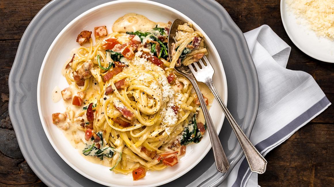 Linguine carbonara with bacon, tomato, and spinach