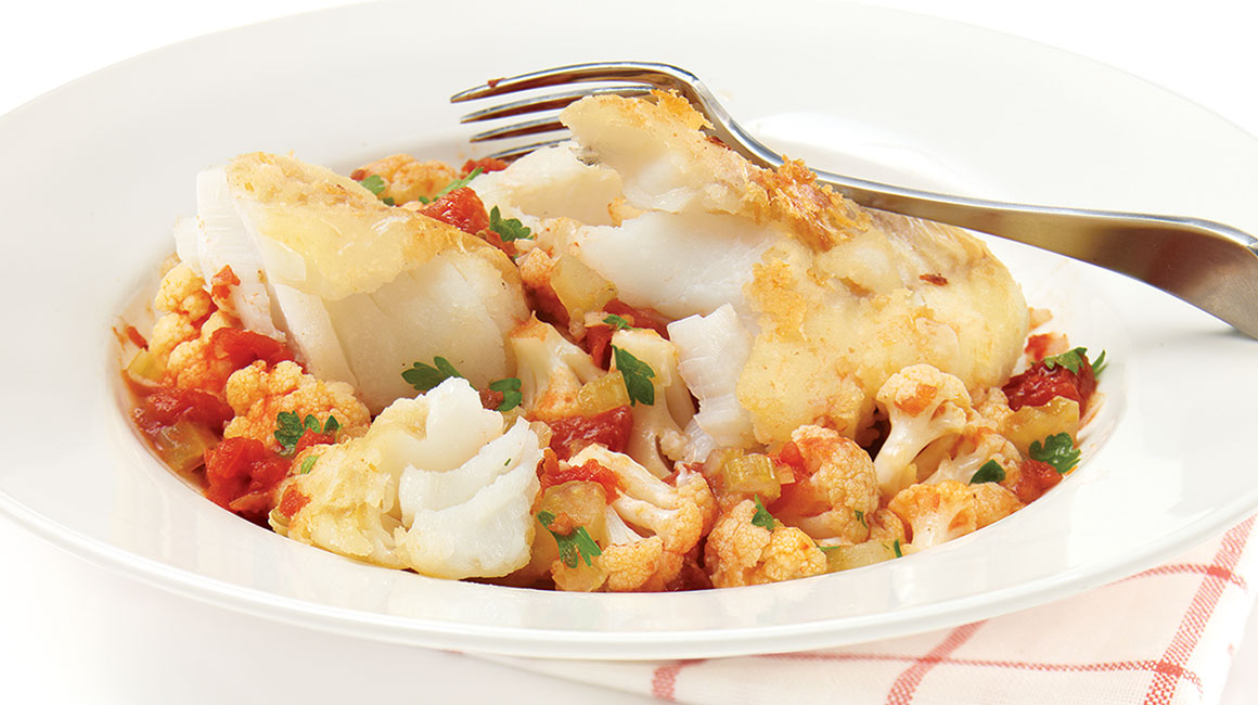 Pan-fried cod over cauliflower and tomatoes