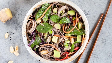 Oriental noodles with crisp vegetables and ginger, cashew, and miso pesto