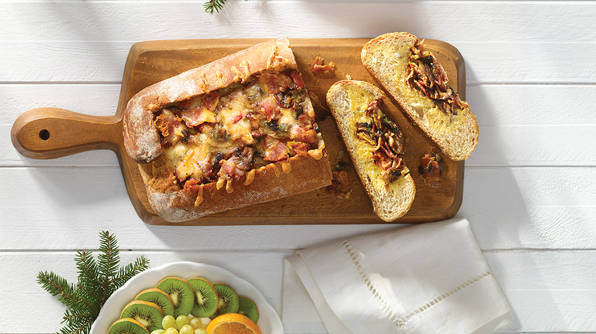 Cheesy country-style bread with eggs, bacon and mushrooms