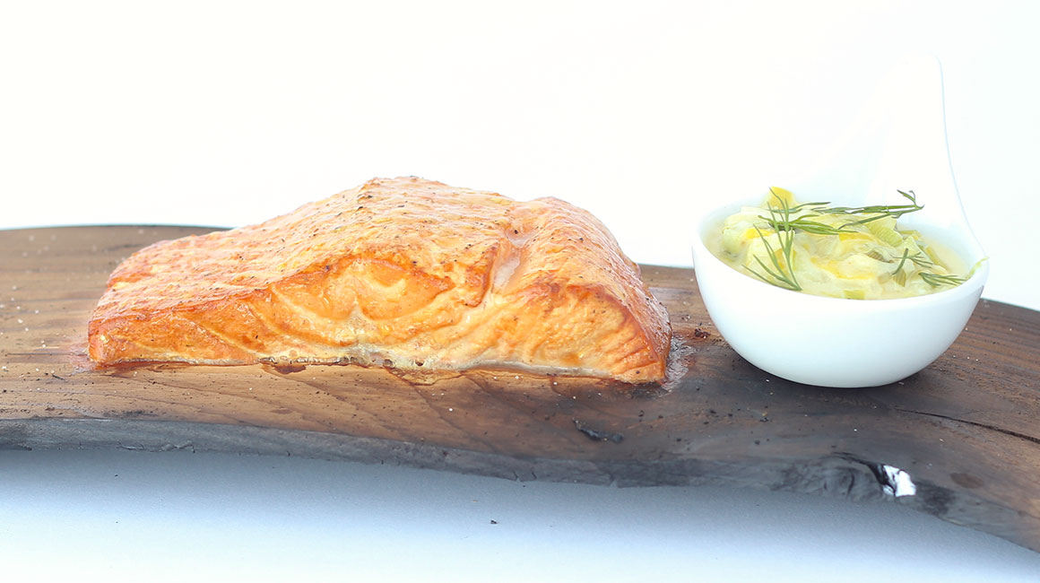 Plank-grilled salmon with creamy leek sauce